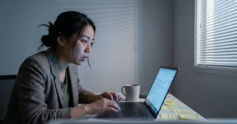 morning routine overwhelm, Asian female entrepreneur reacting to crowded inbox in small home office
