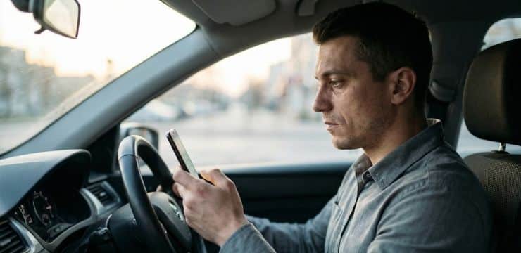Keyword intent strategy decision, founder in parked car at dawn reviewing phone before changing content approach