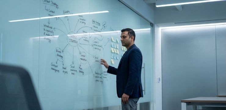 Content library strategy with internal linking, south asian professional reviewing connected content system on glass board