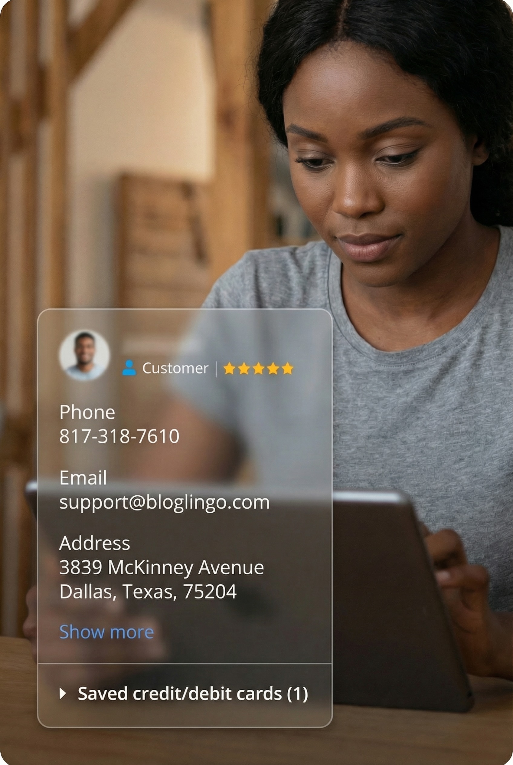 Customer profile interface with reviews and contact details, black woman using tablet in warm indoor setting